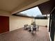 Charming covered brick patio with outdoor seating and a view of the yard at 10631 Village Lake Rd, Windermere, FL 34786
