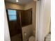 Shower features a shower seat, brown tile, and a shower head at 10631 Village Lake Rd, Windermere, FL 34786