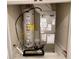 Utility closet with water heater, air conditioning unit, and concrete floor at 10631 Village Lake Rd, Windermere, FL 34786