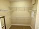 Spacious walk-in closet features carpet and wire shelving for ample storage space at 10631 Village Lake Rd, Windermere, FL 34786