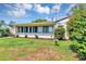 A backyard with manicured lawn, complemented by neat landscaping and a glimpse of the home's architecture at 10856 William Tell Dr, Orlando, FL 32821