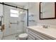Modern bathroom with a tiled shower, glass door, and sleek vanity, combining style and accessibility at 10856 William Tell Dr, Orlando, FL 32821