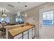 Bright dining area featuring pendant lighting, wood counters, and easy access to the outside with a glass-paneled door at 10856 William Tell Dr, Orlando, FL 32821