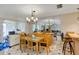 The dining room features natural light, bar seating, chandelier and an open layout at 10856 William Tell Dr, Orlando, FL 32821