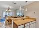 Open-concept dining room features chandelier lighting, bar seating and lots of cabinetry at 10856 William Tell Dr, Orlando, FL 32821