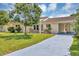 Inviting home with a well-maintained lawn, cozy front patio set, and a convenient attached carport at 10856 William Tell Dr, Orlando, FL 32821