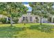 Charming single-story home featuring a well-manicured lawn and mature trees providing ample shade at 10856 William Tell Dr, Orlando, FL 32821