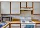 Practical kitchen with wooden countertops, white cabinets, and modern appliances, maximizing space at 10856 William Tell Dr, Orlando, FL 32821