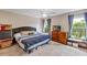 Comfortable main bedroom featuring large windows, ceiling fan, and cozy decor at 10856 William Tell Dr, Orlando, FL 32821