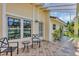 Covered front patio with chairs, potted plants, and tile flooring, ideal for relaxing at 10856 William Tell Dr, Orlando, FL 32821