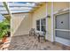 Cozy front patio with tiled flooring, perfect for enjoying outdoor seating under the pergola at 10856 William Tell Dr, Orlando, FL 32821