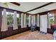Cozy sun room with wood paneled walls, plush carpet and lots of natural light at 10856 William Tell Dr, Orlando, FL 32821