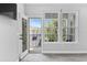 Inviting balcony offering views of lush greenery and neighborhood charm through large windows at 117 E Concord St # 7, Orlando, FL 32801