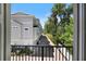 Balcony view featuring a row of townhouses along a brick-paved street, accented by mature trees and a blue sky above at 117 E Concord St # 7, Orlando, FL 32801