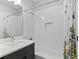 Bright bathroom featuring a modern vanity with a quartz countertop and a shower-tub combo at 117 E Concord St # 7, Orlando, FL 32801