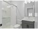 Modern bathroom featuring a glass-enclosed shower, gray vanity, and hexagon tile flooring at 117 E Concord St # 7, Orlando, FL 32801
