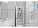 Bright bathroom featuring a double sink vanity with a quartz countertop and a glass shower at 117 E Concord St # 7, Orlando, FL 32801