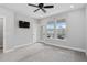 Spacious bedroom featuring neutral walls, plush carpeting, and a door to a private balcony at 117 E Concord St # 7, Orlando, FL 32801