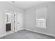 Light-filled bedroom with neutral gray carpet, ensuite bathroom, and a bright window at 117 E Concord St # 7, Orlando, FL 32801