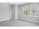 Bedroom showcasing neutral walls, carpet flooring, and natural light from large windows at 117 E Concord St # 7, Orlando, FL 32801