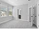 Bedroom featuring neutral walls, carpet flooring, natural light, and an attached bathroom at 117 E Concord St # 7, Orlando, FL 32801