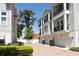 Beautiful townhomes featuring private garages, brick paved driveway, and balconies on a sunny day at 117 E Concord St # 7, Orlando, FL 32801