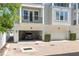 Townhome featuring a convenient drive-in garage and a brick-paved entrance at 117 E Concord St # 7, Orlando, FL 32801