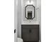 Elegant half bathroom featuring a modern vanity with dark gray cabinets and stylish mirror at 117 E Concord St # 7, Orlando, FL 32801