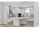 Modern kitchen with white cabinetry, stainless steel appliances, a center island with quartz countertops, and stylish pendant lighting at 117 E Concord St # 7, Orlando, FL 32801