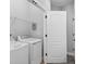 Well lit laundry room with modern washer and dryer and wire shelving at 117 E Concord St # 7, Orlando, FL 32801