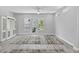 Bright, open living room featuring light gray walls and wood floors, complemented by a stylish area rug and built-in cabinetry at 117 E Concord St # 7, Orlando, FL 32801