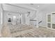 Inviting open-concept living space with hardwood floors, a staircase, and a modern kitchen featuring a center island at 117 E Concord St # 7, Orlando, FL 32801