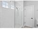 Bright shower featuring white subway tile, mosaic tile floor, a glass door and windows at 117 E Concord St # 7, Orlando, FL 32801