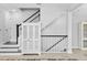 Staircase with white risers, dark treads, and a charming built-in cabinet, adding character to the space at 117 E Concord St # 7, Orlando, FL 32801