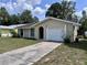Charming one-story home featuring an attached one car garage and arched doorway at 117 N Alderwood St, Winter Springs, FL 32708