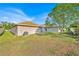 Large backyard with mature tree, patio, and well-maintained lawn, perfect for outdoor enjoyment at 125 Owenshire Cir, Kissimmee, FL 34744