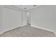 Bright, neutral bedroom with white closet doors and laminate flooring at 125 Owenshire Cir, Kissimmee, FL 34744