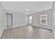 Bright bedroom featuring neutral paint and flooring, large windows, and ample closet space at 125 Owenshire Cir, Kissimmee, FL 34744