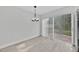 Bright dining area with modern chandelier and sliding glass doors to the outdoor patio at 125 Owenshire Cir, Kissimmee, FL 34744