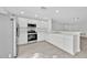 Bright kitchen with white cabinets, stainless steel appliances, and laminate flooring at 125 Owenshire Cir, Kissimmee, FL 34744