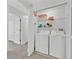 A well-lit laundry closet with washer, dryer, and plenty of storage space at 125 Owenshire Cir, Kissimmee, FL 34744