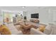 Bright and airy living room with wood flooring, modern furniture, and open kitchen at 125 Owenshire Cir, Kissimmee, FL 34744
