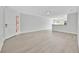 Bright living room featuring wood laminate flooring and white trim at 125 Owenshire Cir, Kissimmee, FL 34744