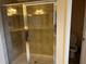 Bathroom featuring tiled shower stall with glass doors and neutral color palette at 12610 Sawgrass Oak St, Orlando, FL 32824