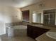 The bathroom features a corner soaking tub, double sinks, and a glass-enclosed shower at 12610 Sawgrass Oak St, Orlando, FL 32824