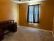 Bedroom with neutral carpet, a dark wood desk, and a window with dark curtains at 12610 Sawgrass Oak St, Orlando, FL 32824