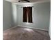 Cozy bedroom with neutral walls, soft carpeting, ceiling fan, and ample natural light at 12610 Sawgrass Oak St, Orlando, FL 32824