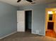 This bedroom features neutral carpet, light blue walls, and doorways to a walk-in closet and bathroom at 12610 Sawgrass Oak St, Orlando, FL 32824