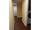 Hallway with wood-look floors leading to the laundry room at 12610 Sawgrass Oak St, Orlando, FL 32824