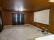 Spacious carpeted living room with brown walls and a movie screen at 12610 Sawgrass Oak St, Orlando, FL 32824